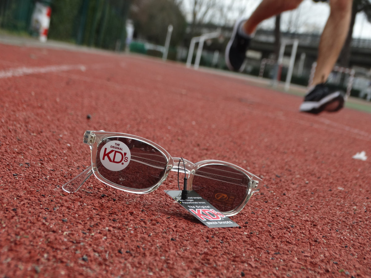 A jogger on a track running next to KD's sunglasses.