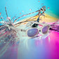 KD's 22018 sunglasses that fit under a motorcycle or ski helmet. For outdoor activities. With a transparent frame and iridescent mirror lenses. Posed in a burst of paint.